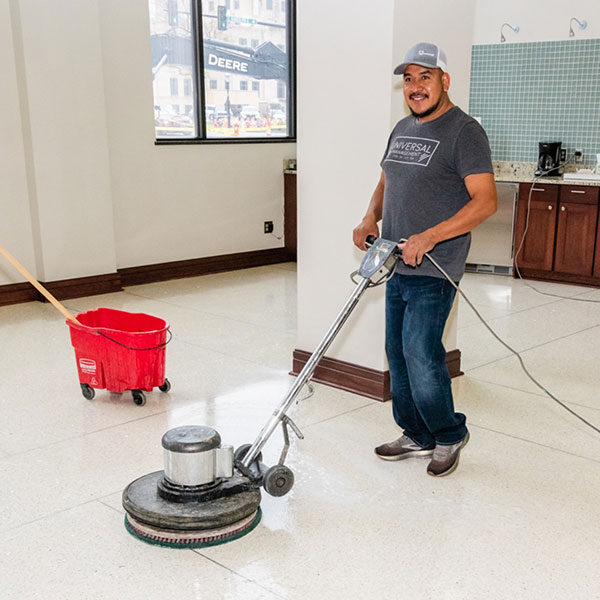 Gerardo cleaning the floor with machine